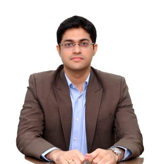 Portrait of a person in a brown suit and blue shirt