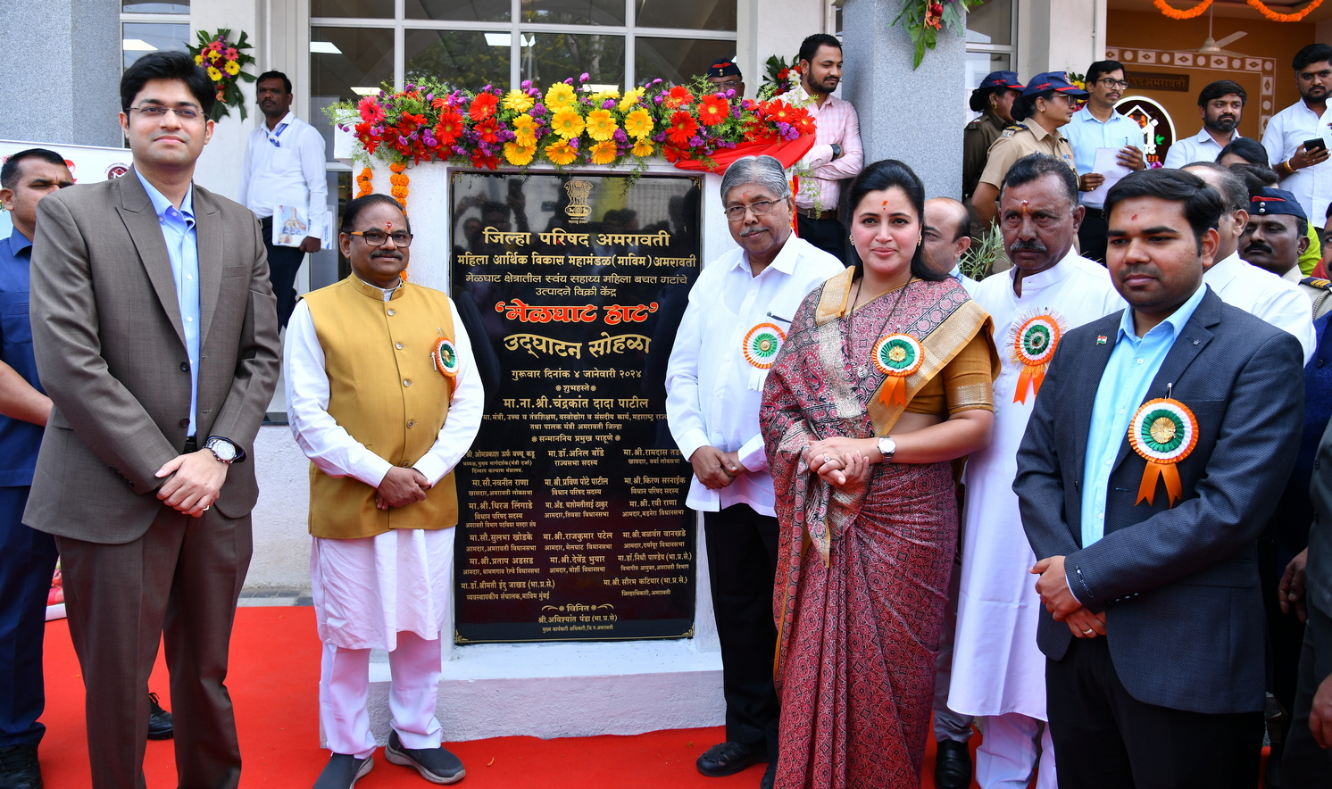 Group of people standing in front of a plaque