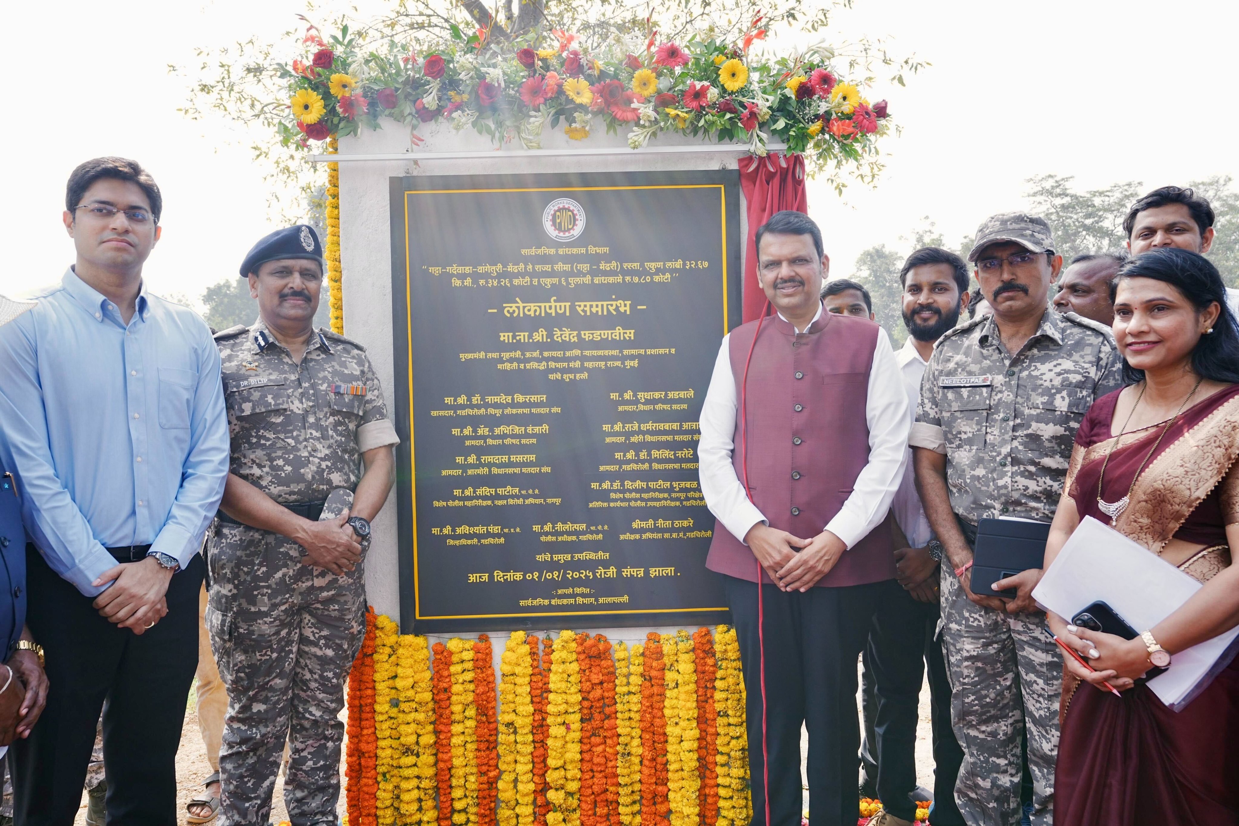 Group of people standing in front of a plaque